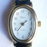 Vintage Timex womens quartz watch - gold tone oval case, white dial and black strap Image 4
