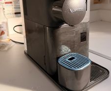 Nescafe Delonghi Coffee Machine with milk frother attached