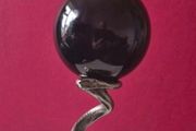 Obsidian glass ball and metal Serpent stand.