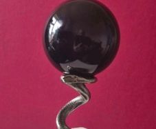 Obsidian glass ball and metal Serpent stand.