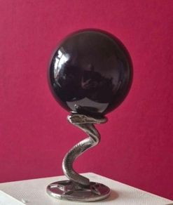 Obsidian glass ball and metal Serpent stand.