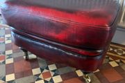 Leather Footstool on brass Castors.