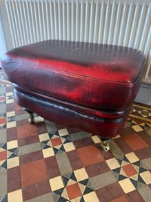 Leather Footstool on brass Castors.