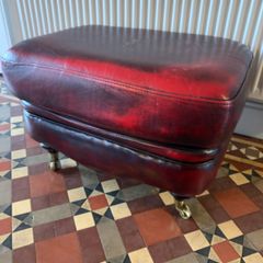 Leather Footstool on brass Castors.