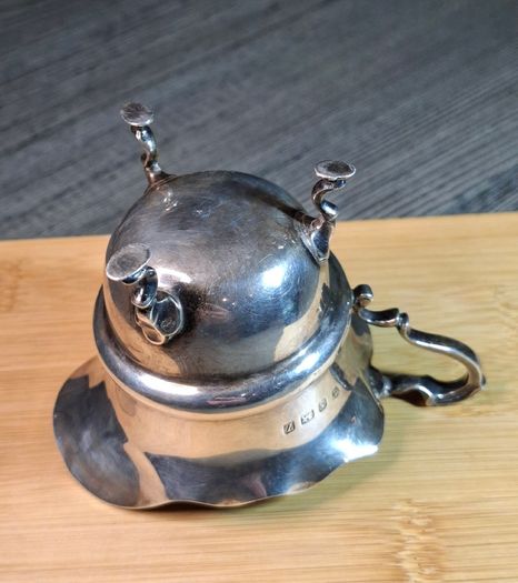 Antique silver cream jug with scalloped rim