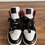 Nike Air Jordan 1 Mid trainers in the classic black, white and red colourway Image 6