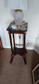 a pair of beautiful vintage tables with marble tops