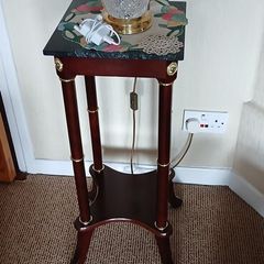 a pair of beautiful vintage tables with marble tops