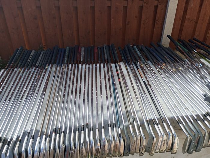 A selection of golf clubs and bags. All right handed clubs.