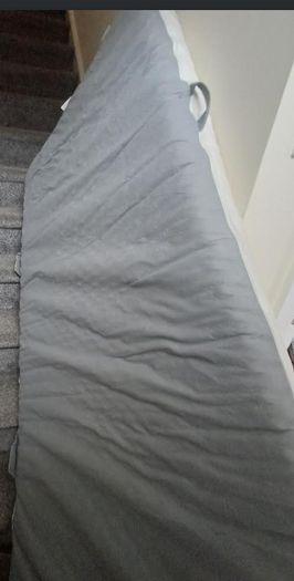 Twin bed, quite high, to store things underneath