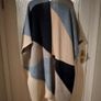 Monsoon Colourblock Knit Poncho. The design features an abstract, geometric color-block pattern with shades of blue, grey, and cream and Navy. Image 5