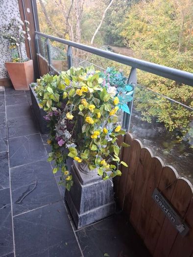 Cast garden Urn with artificial flowers