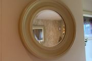 Round mirror in subtle beige.