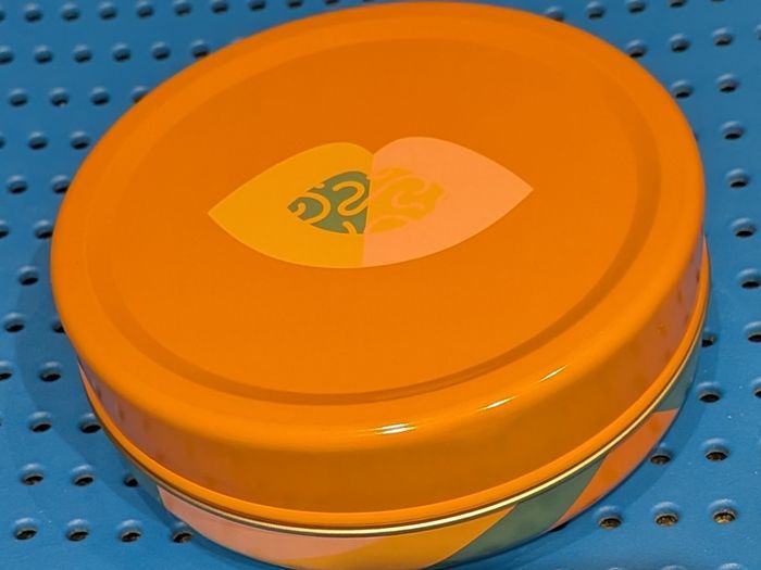 Colourful circular tin box