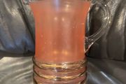 Peach pincher/jug with gold trim.