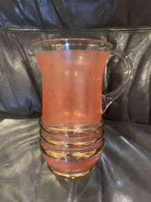 Peach pincher/jug with gold trim.