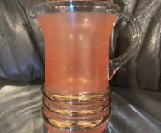 Peach pincher/jug with gold trim.