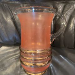 Peach pincher/jug with gold trim.