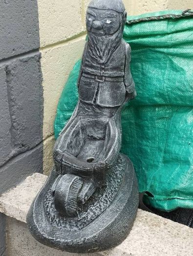 Man holding a wheelbarrow planter