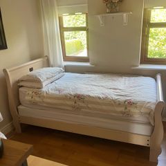 Beautiful cream single sleigh bed. Mattress included.