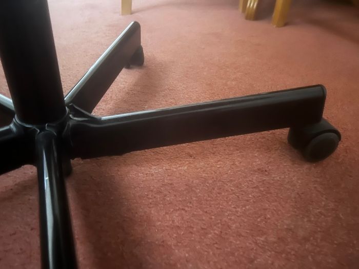 Ikea chair with one leg of the base broken