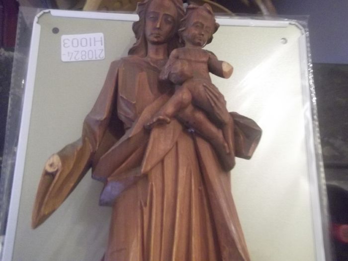 a carved wooden holy figure