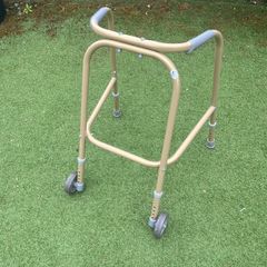 Child's walking aid (Zimmerframe) gold colour