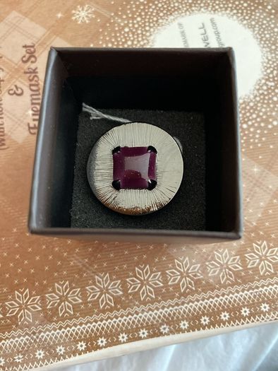 Ring with purple centre stone, signed IKITA