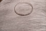 Silver tone bracelet with blue stones and words on it