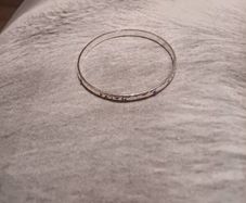 Silver tone bracelet with blue stones and words on it