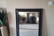 Modern black framed mirror in excellent condition.