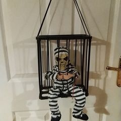 Halloween decorations. Freak in a cage.