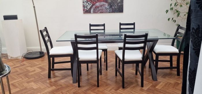 Glass and black wooden frame dining table with black & white chairs x6 or x8
