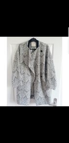 Maje black and white Gadget coat. Mid-weight cotton-jacquard. Front slit pockets, goat trim, fully lined. Asymmetric button fastenings through front. 79% cotton