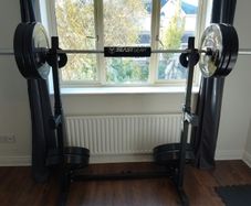 155kg Bumper Plate Set 7ft Olympic Bar and adjustable Squat Stands.
