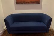 Blue velvet couch with wooden legs