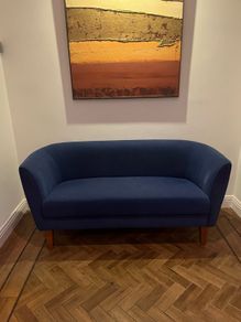 Blue velvet couch with wooden legs