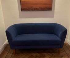 Blue velvet couch with wooden legs
