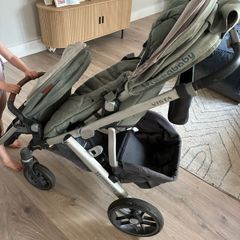 Uppababy buggy with scooter board, basinet, and roamer seat.