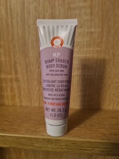 First Aid Beauty KP Bump Eraser Body Scrub with 10% AHA, which is a targeted body treatment formulated to address Keratosis Pilaris (KP)