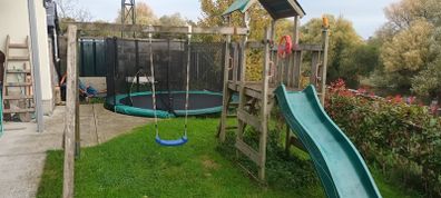 Wooden swing and slide climbing frame