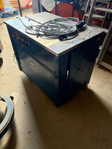 Box strapper machine