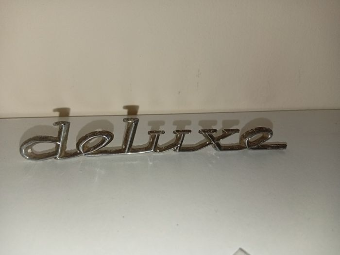 Classic Car " DELUXE " CAR BADGE, Good condition with 2 mounting pins vintage