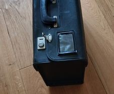 Black leather case. 19ins wide.14ins high. 4ins deep