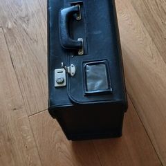 Black leather case. 19ins wide.14ins high. 4ins deep