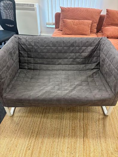 Grey quilted sofa with white metal frame