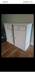 Matching pair of solid wood bedside lockers / cabinets.