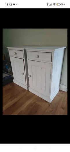 Matching pair of solid wood bedside lockers / cabinets.