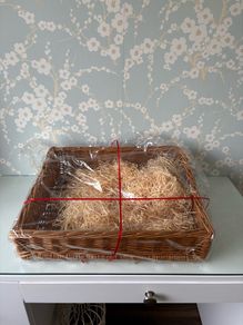 Large sturdy gift basket with stray filling & Red ribbon.