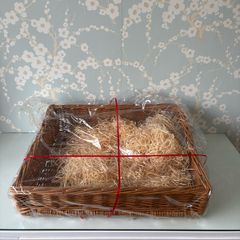 Large sturdy gift basket with stray filling & Red ribbon.